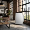 Klimatyzator przenośny TCL TAC CPB w salonie w stylu loft z industrialnymi oknami i ceglaną ścianą